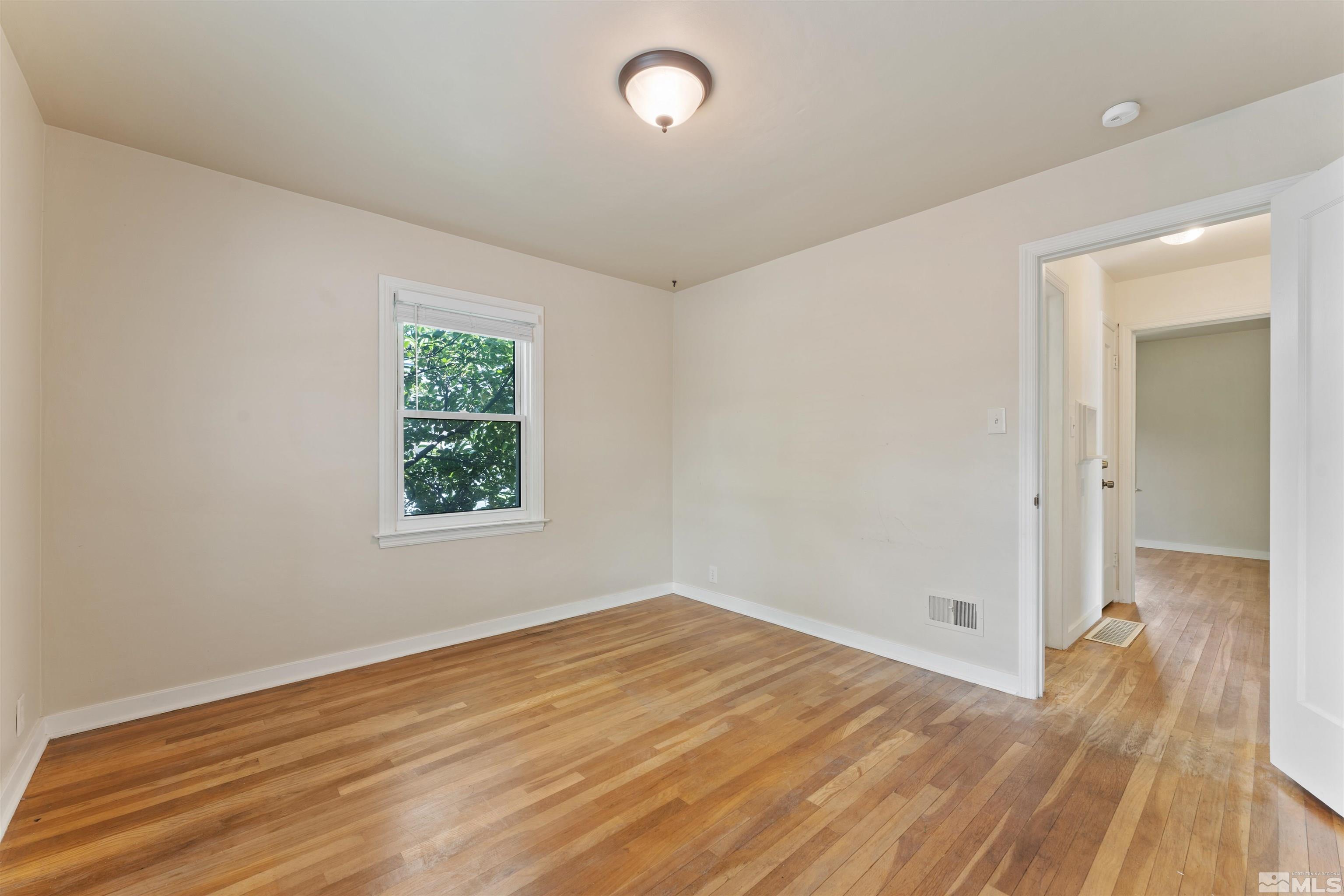 1624 Watt Street Reno, NV 89509 - Photo 23 of 40 an empty room with wooden floor and windows
