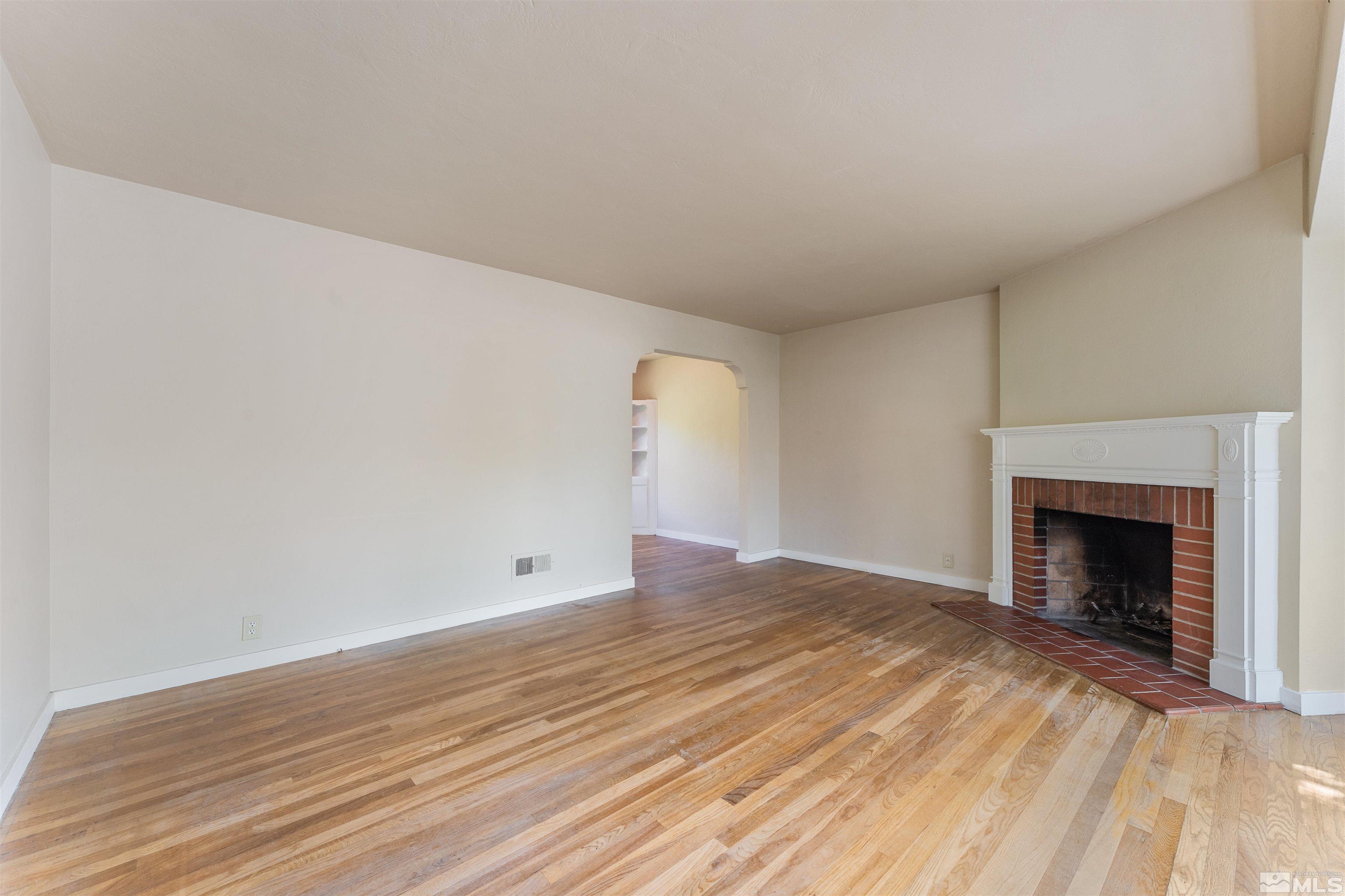 1624 Watt Street Reno, NV 89509 - Photo 4 of 40 a view of empty room with wooden floor and fireplace