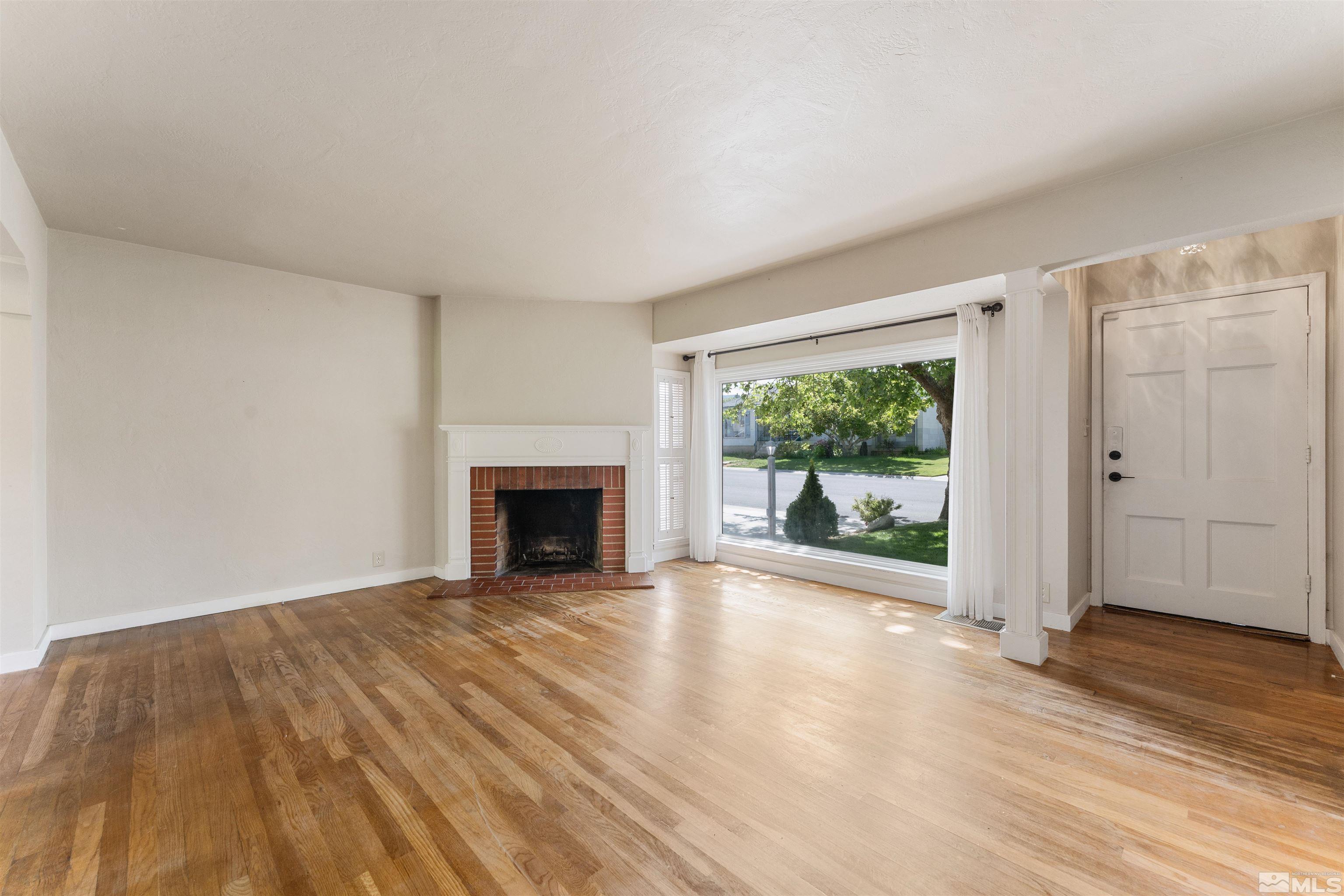 1624 Watt Street Reno, NV 89509 - Photo 6 of 40 a view of a livingroom with wooden floor a fireplace and window