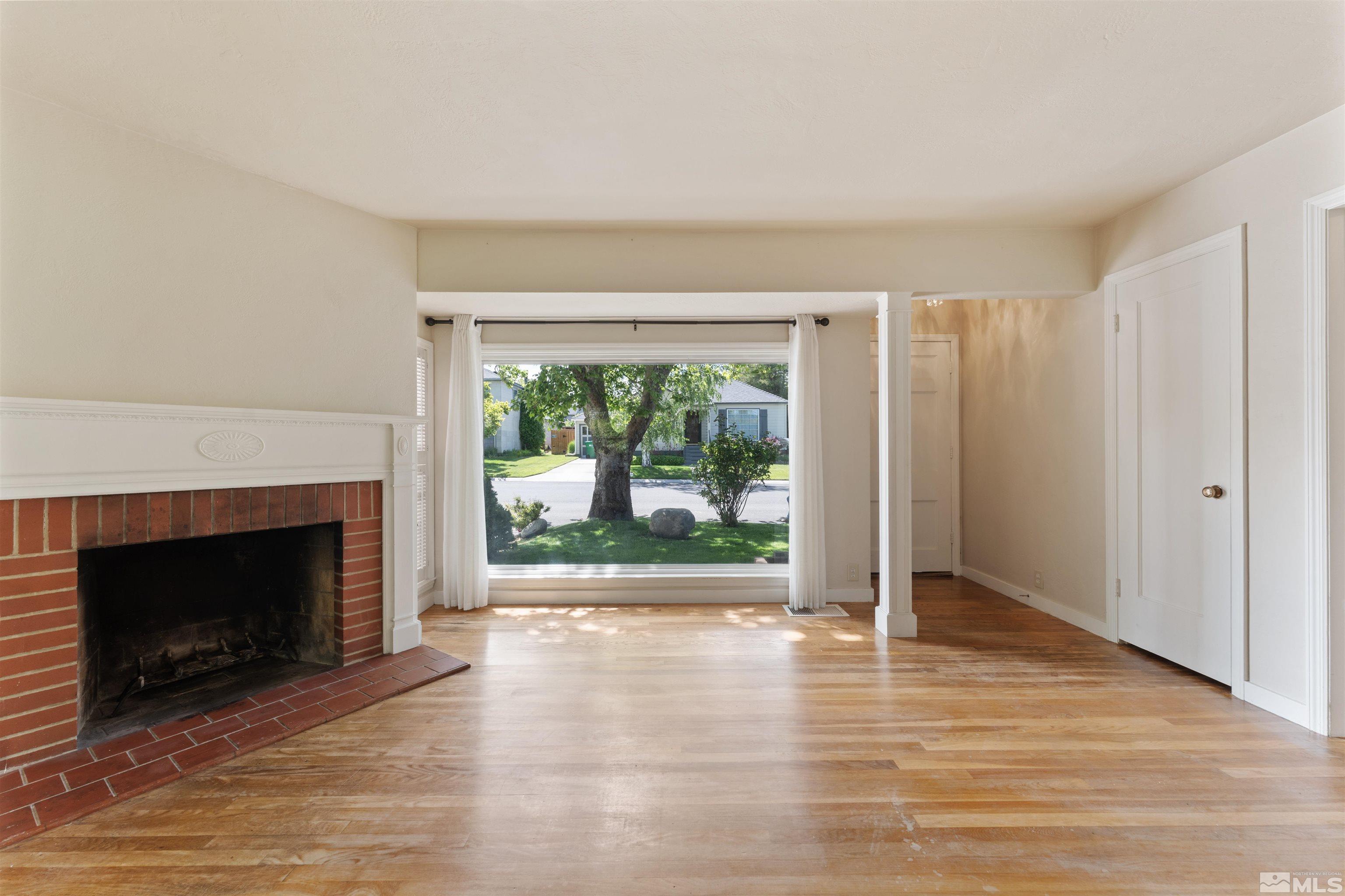 1624 Watt Street Reno, NV 89509 - Photo 7 of 40 a view of empty room with wooden floor and fireplace