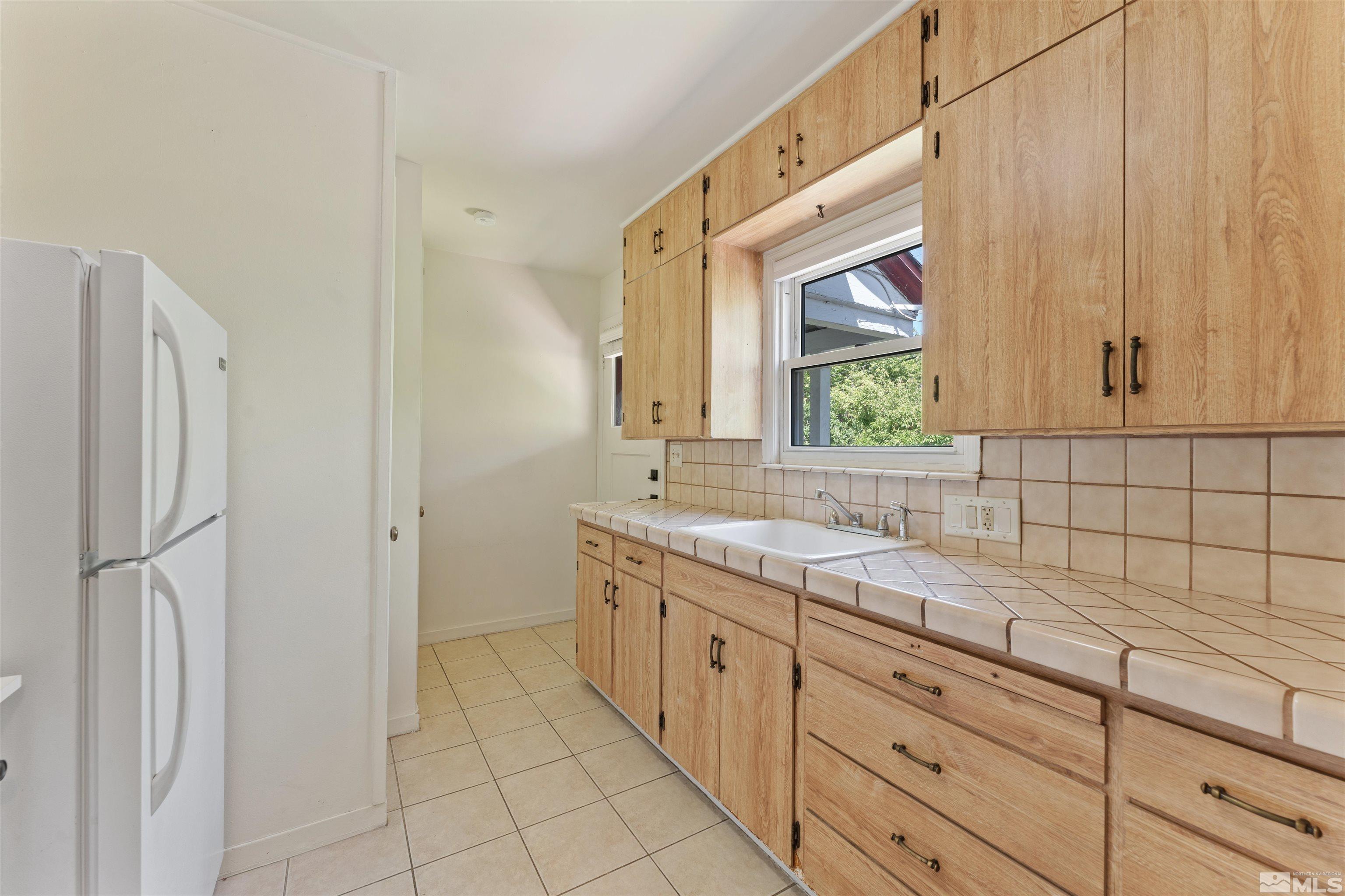 1624 Watt Street Reno, NV 89509 - Photo 10 of 40 a kitchen with a sink cabinets and window