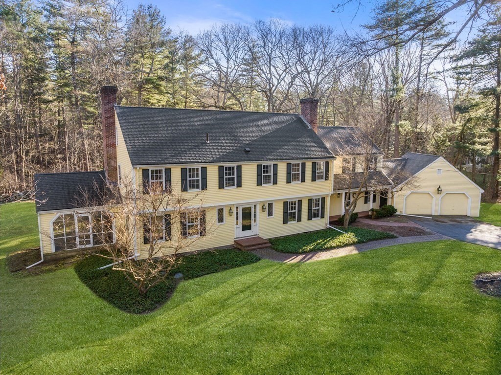 140 Cherry Brook Road Weston, MA 02493 - Photo 1 of 32 a front view of a house with a garden and trees