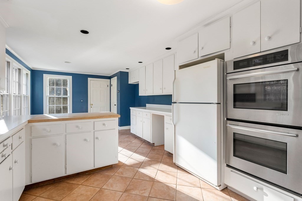 140 Cherry Brook Road Weston, MA 02493 - Photo 11 of 32 a kitchen with granite countertop white cabinets and white appliances