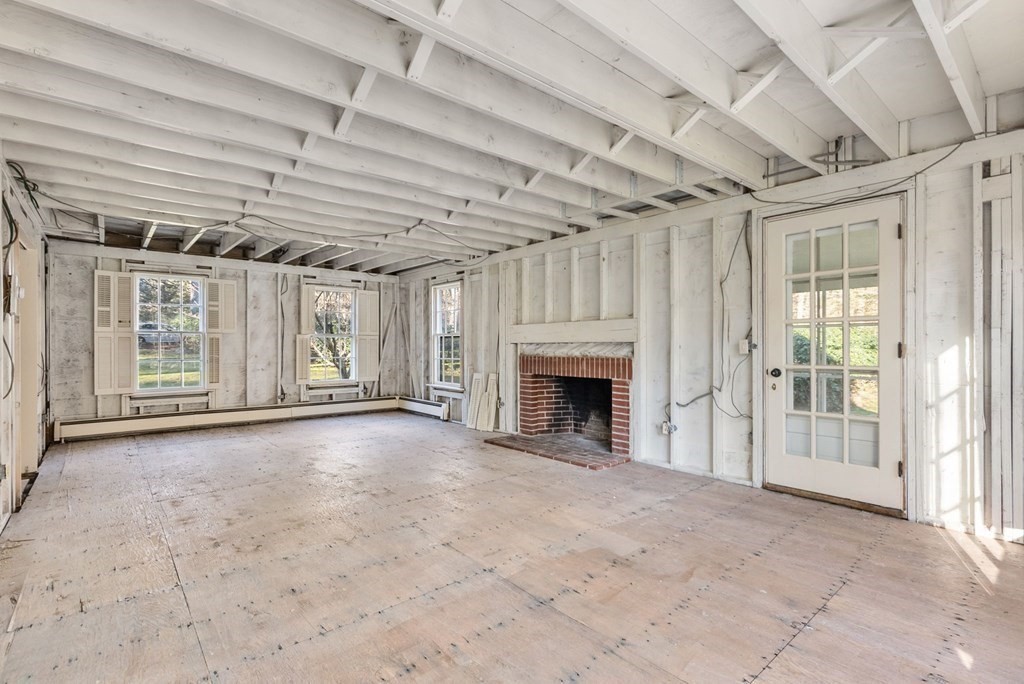 140 Cherry Brook Road Weston, MA 02493 - Photo 17 of 32 a view of empty room with wooden floor and fireplace