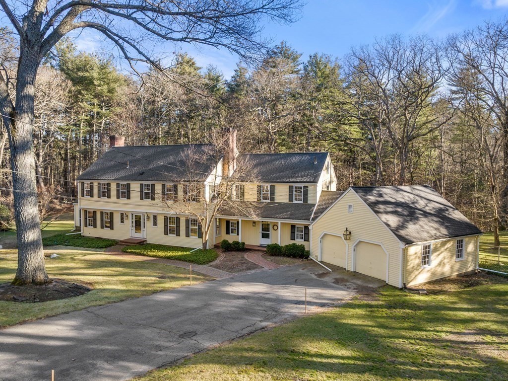 140 Cherry Brook Road Weston, MA 02493 - Photo 2 of 32 a view of a white house next to a big yard and large trees