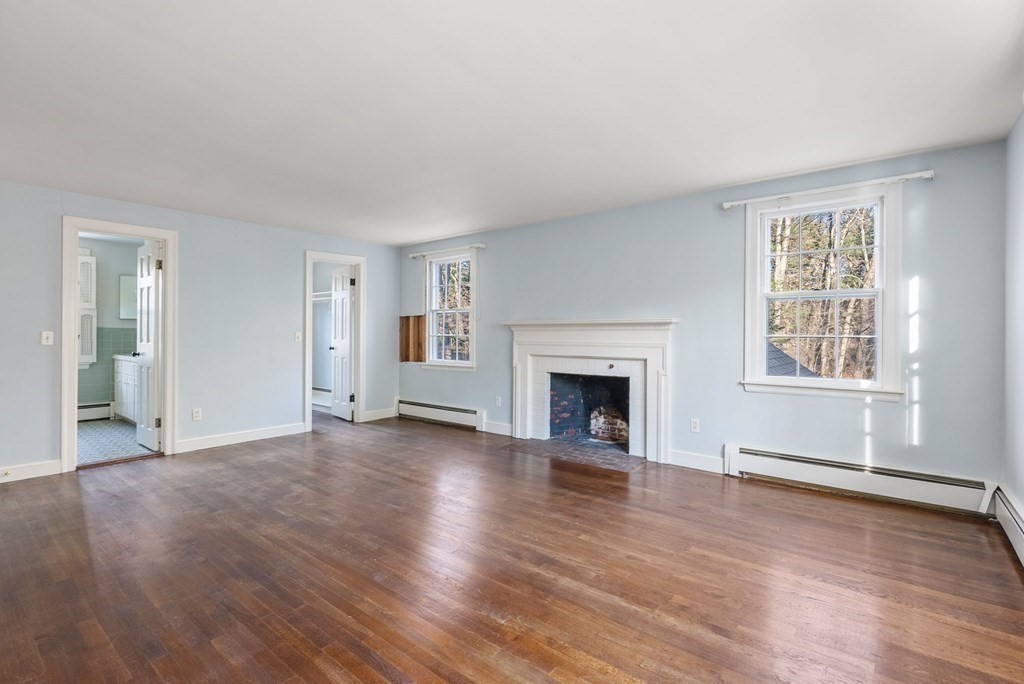 140 Cherry Brook Road Weston, MA 02493 - Photo 23 of 32 an empty room with wooden floor fireplace and windows