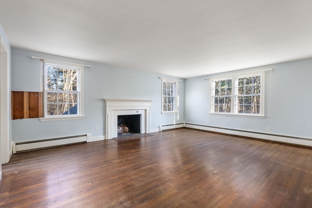 140 Cherry Brook Road Weston, MA 02493 - Photo 24 of 32 an empty room with wooden floor fireplace and windows
