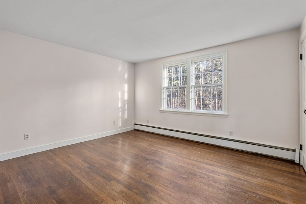 140 Cherry Brook Road Weston, MA 02493 - Photo 26 of 32 an empty room with wooden floor and windows