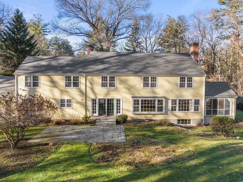 140 Cherry Brook Road Weston, MA 02493 - Photo 32 of 32 a front view of a house with a yard table and chairs