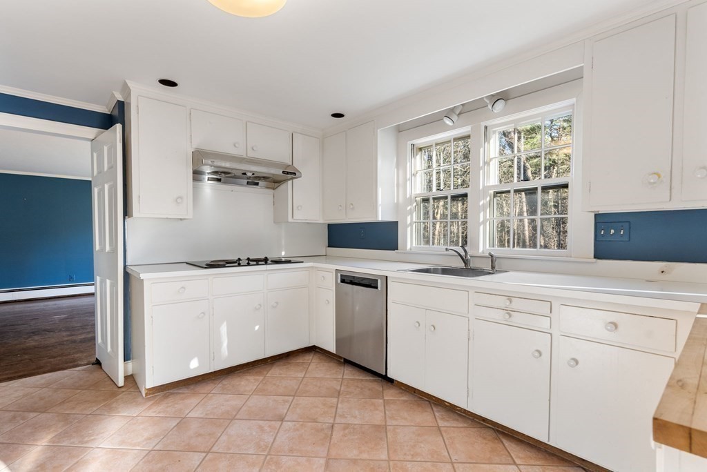 140 Cherry Brook Road Weston, MA 02493 - Photo 9 of 32 a kitchen with white cabinets and white appliances