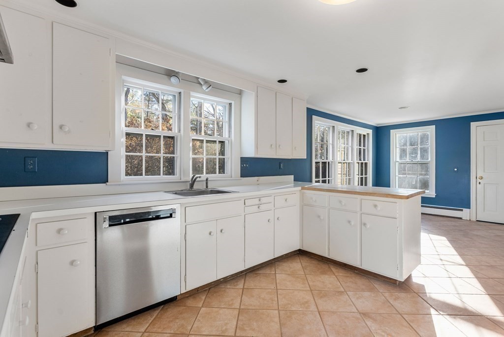 140 Cherry Brook Road Weston, MA 02493 - Photo 10 of 32 a kitchen with granite countertop white cabinets and white appliances