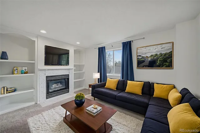 a living room with furniture and a fireplace