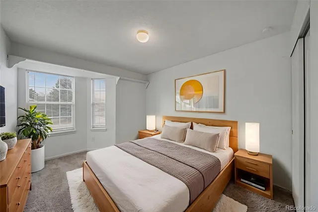 a bedroom with a bed and potted plant