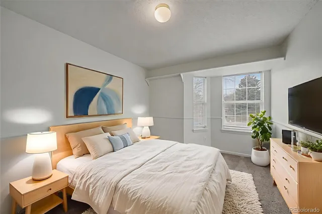 a bedroom with a bed and a flat screen television