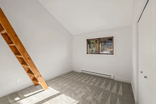 a view of room with stairs and a rug