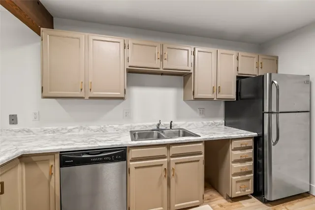 a kitchen with stainless steel appliances granite countertop a refrigerator sink and cabinets
