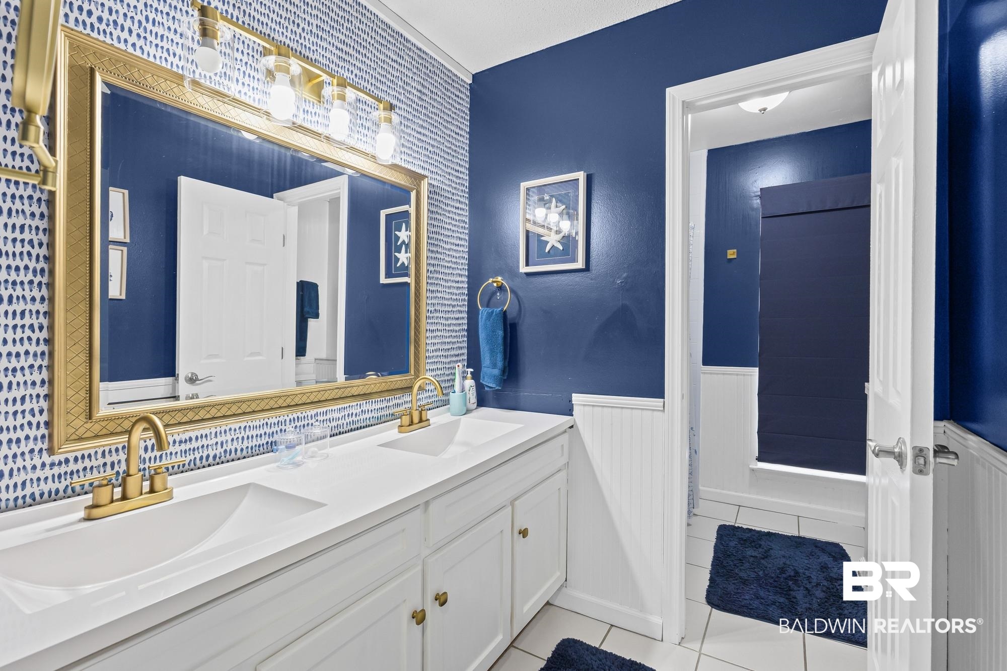 6609 Blakeley Court Mobile, AL 36695 - Photo 14 of 28 Full bath featuring wainscoting, double vanity, and light tile patterned flooring