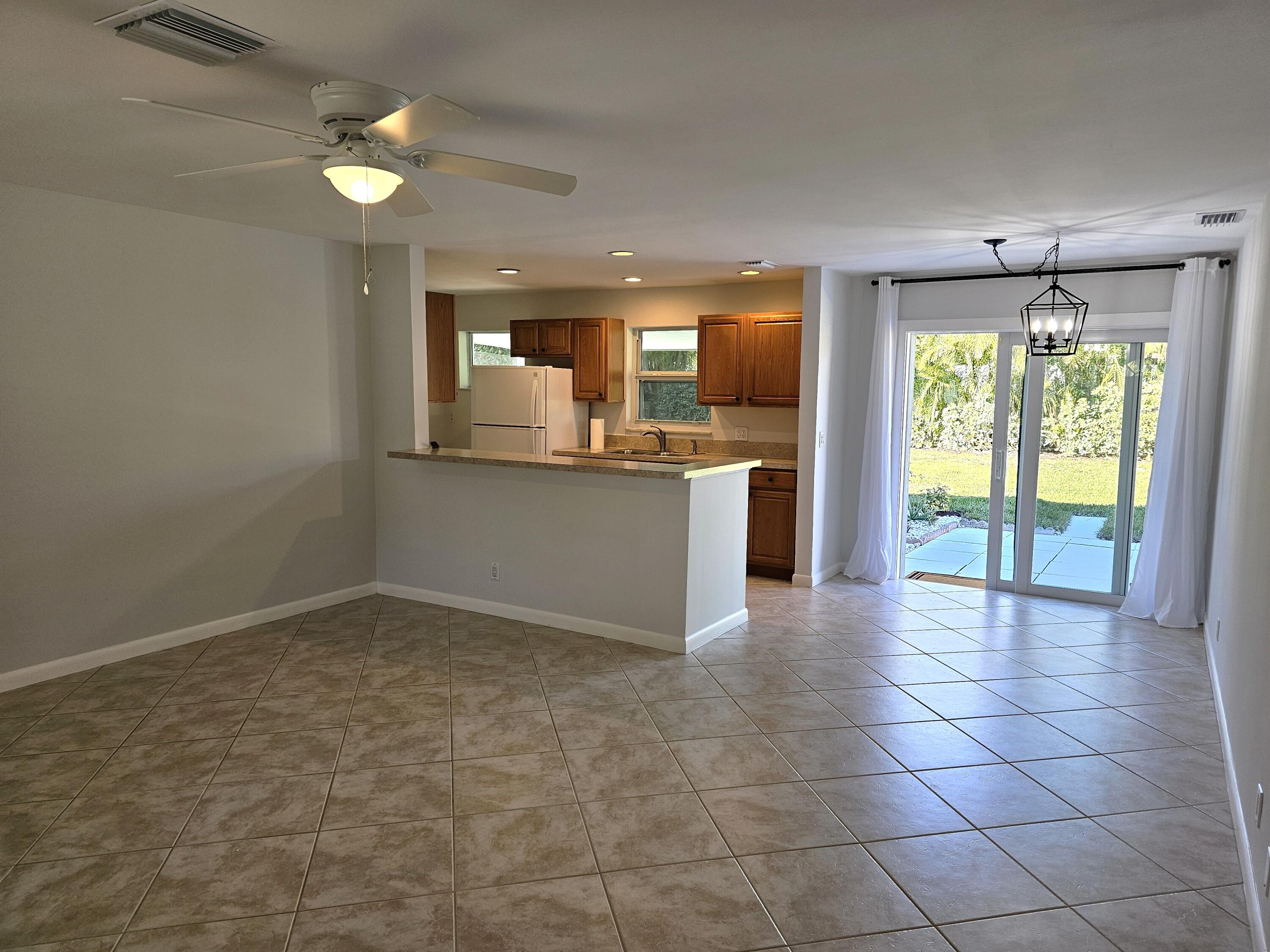355 Franklin Road Tequesta, FL 33469 - Photo 13 of 33 Liv Room to kitchen and back patio