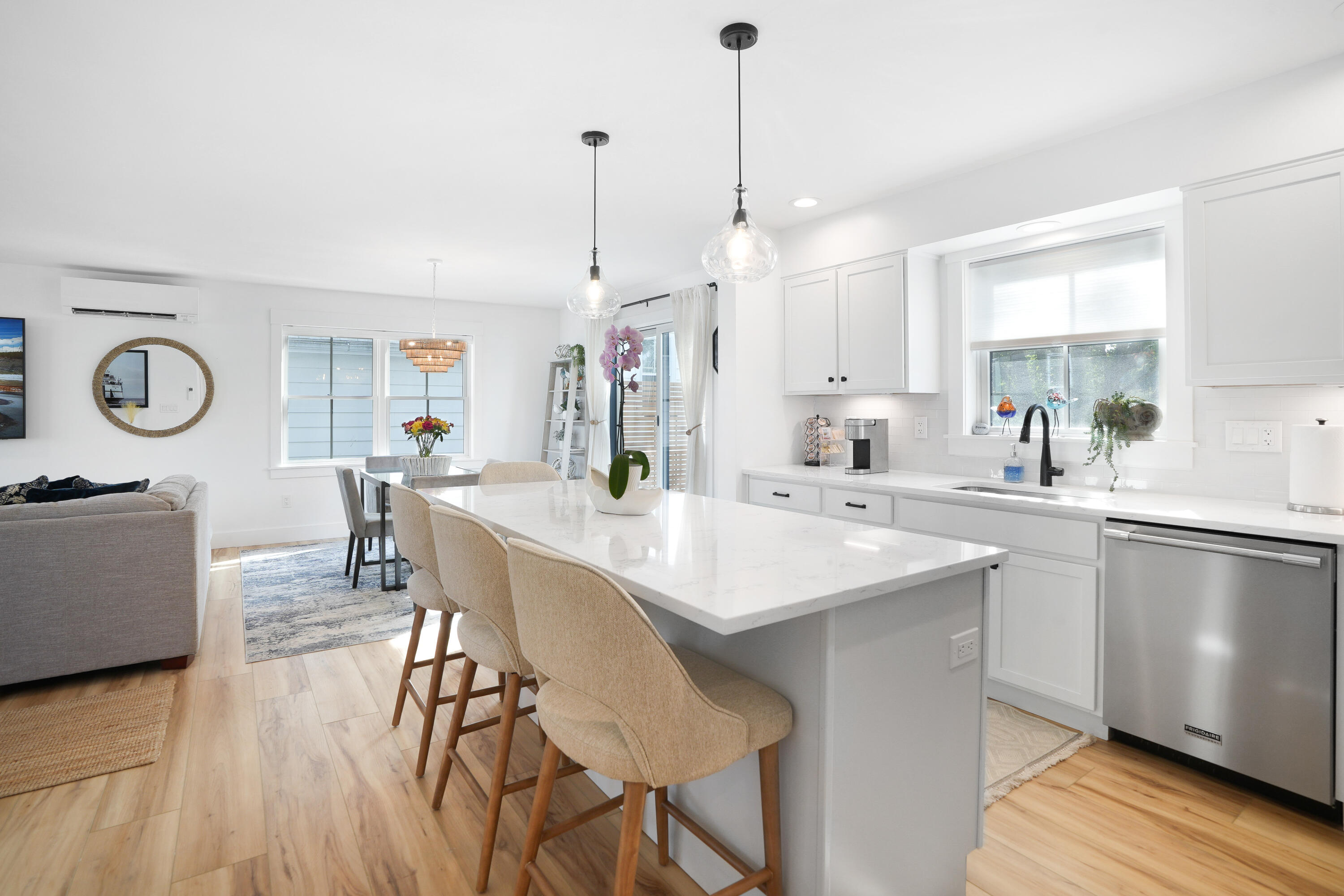 33 Lagoon Pond Road Vineyard Haven, MA 02568 - Photo 16 of 42 a kitchen with stainless steel appliances a dining table chairs sink and wooden floor
