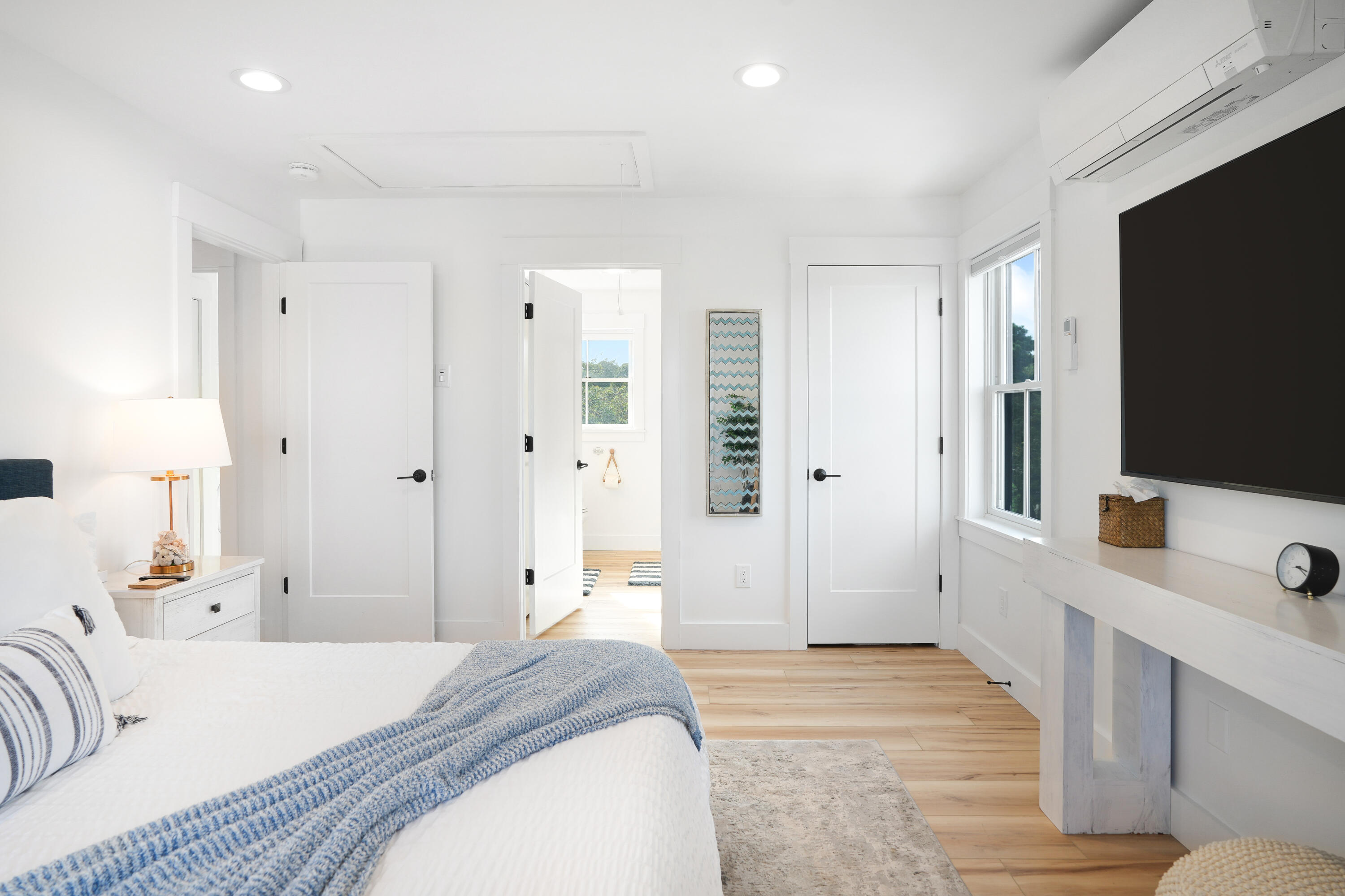 33 Lagoon Pond Road Vineyard Haven, MA 02568 - Photo 25 of 42 a spacious bedroom with a bed and a flat screen tv