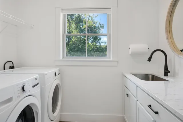 a bedroom with a bed and a flat tv screen on the dresser