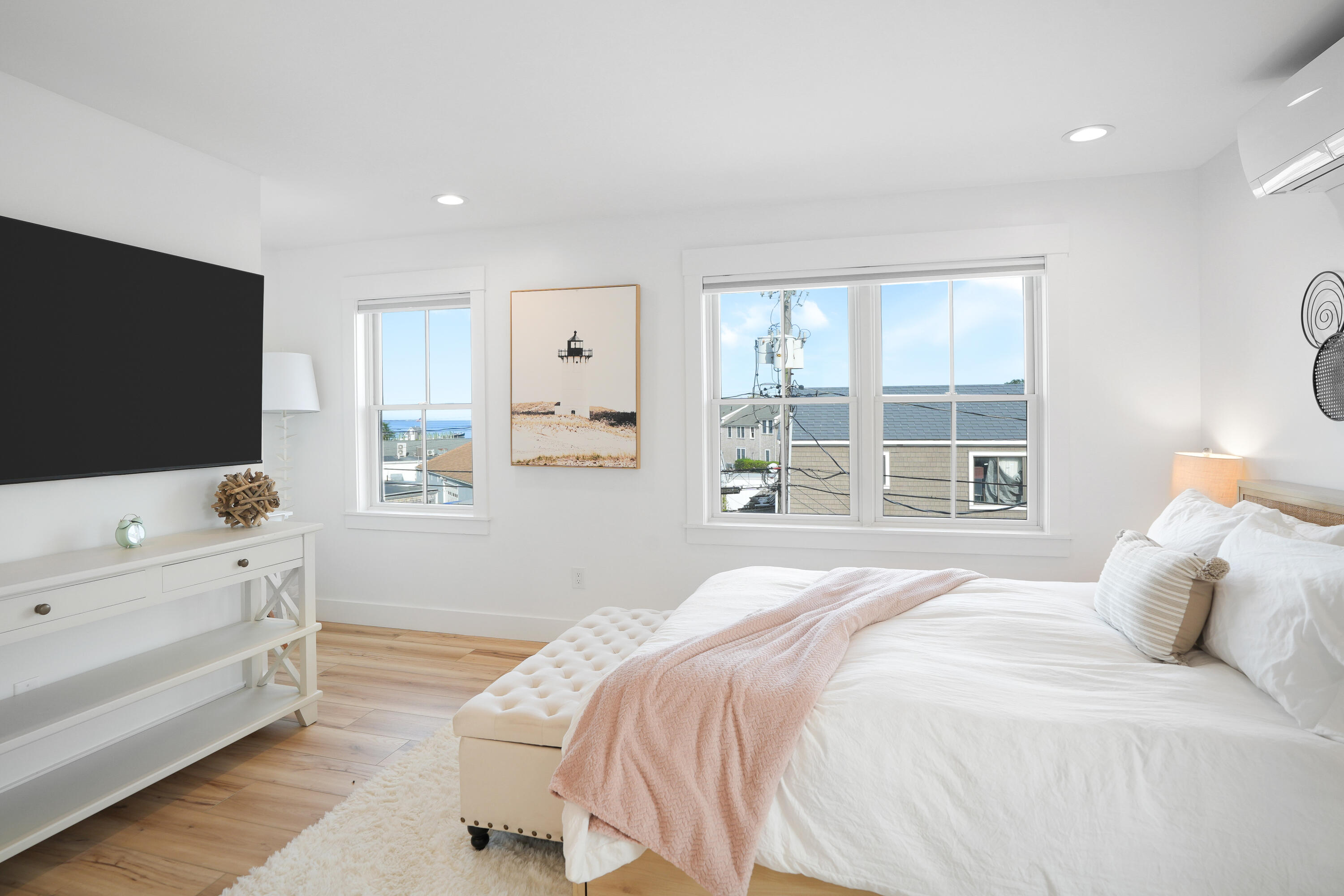 33 Lagoon Pond Road Vineyard Haven, MA 02568 - Photo 30 of 42 a bedroom with a bed and a flat tv screen on the dresser