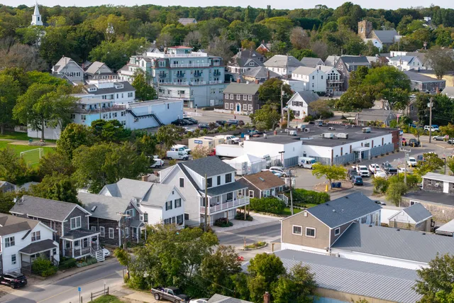 an aerial view of a house with a garden and swimming pool