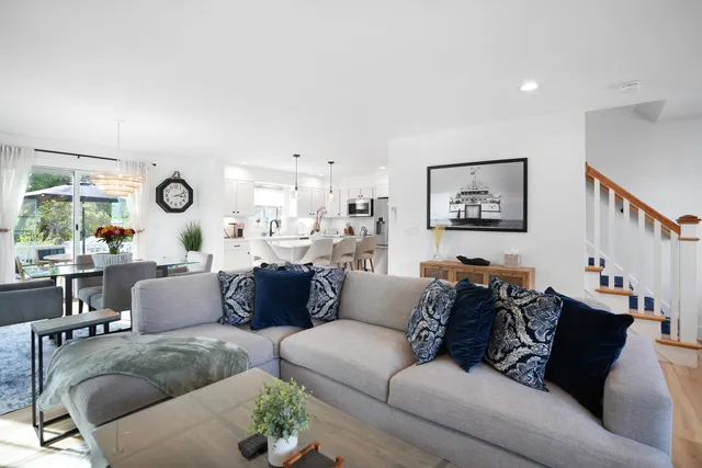 a living room with furniture and a mirror