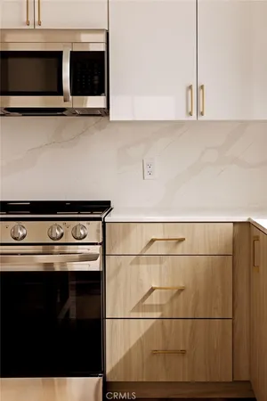 a kitchen with a stove refrigerator and microwave