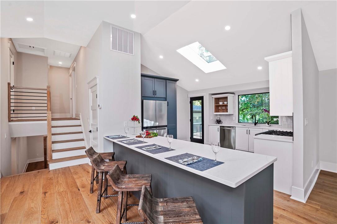 a large kitchen with a table and chairs