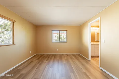 a view of a kitchen with wooden floor and stainless steel appliances