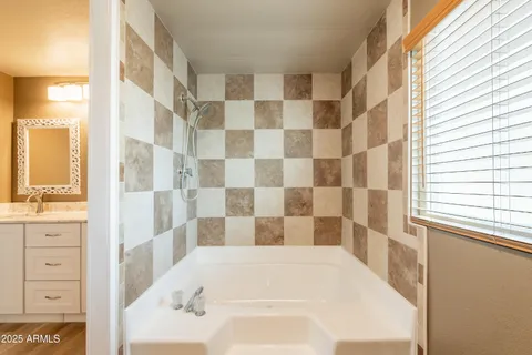 a bathroom with a double vanity sink and a mirror