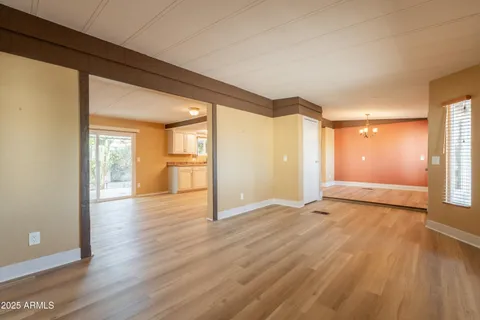 a view of an empty room and wooden floor