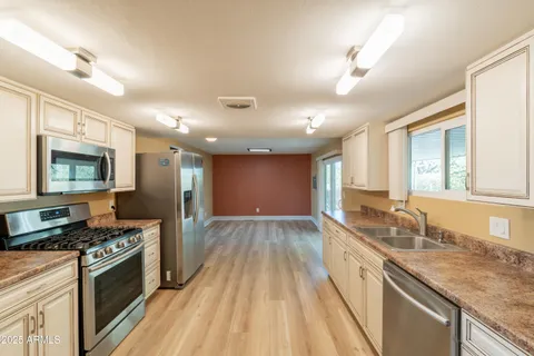 a kitchen with granite countertop cabinets and window