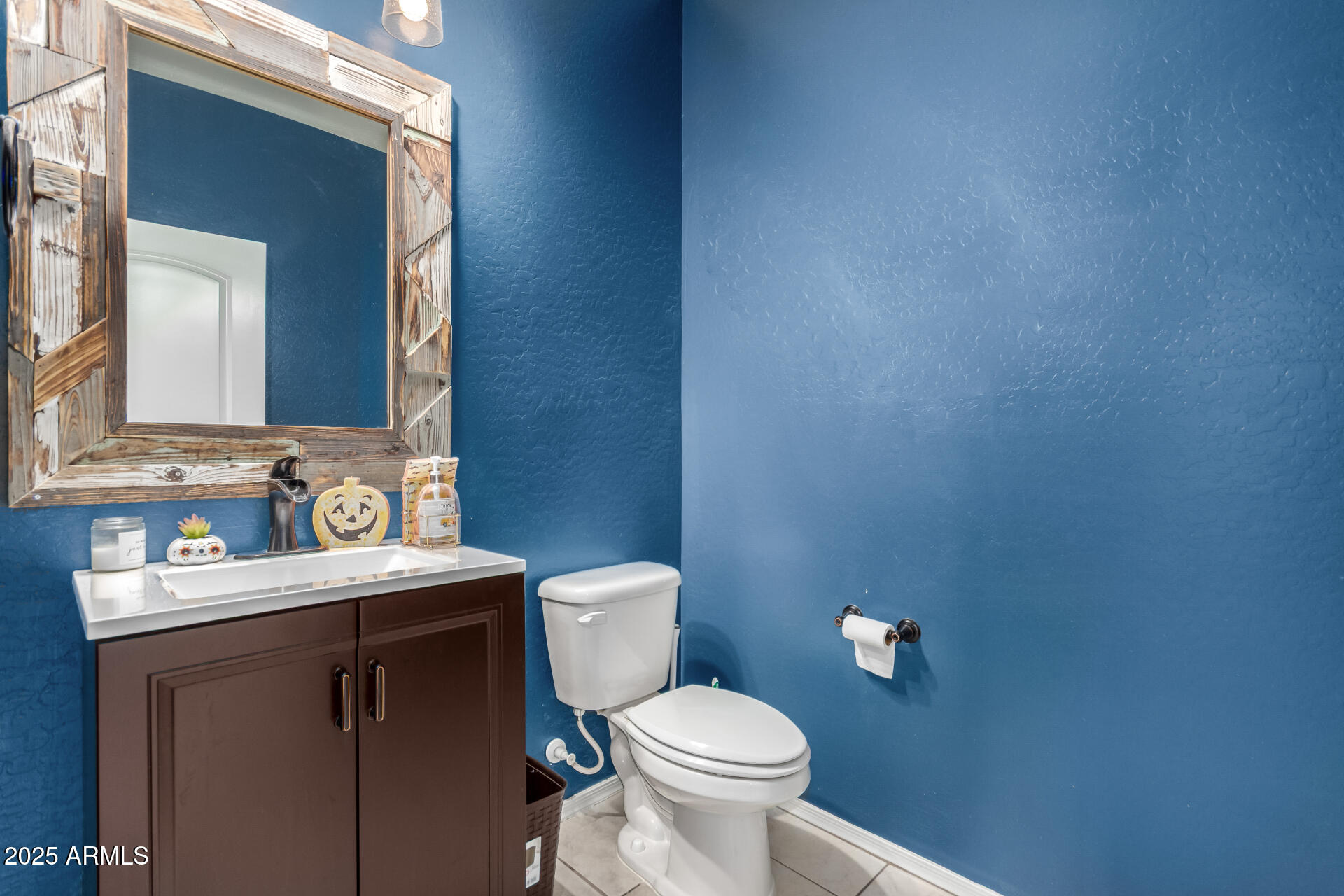 30879 West Picadilly Road Buckeye, AZ 85396 - Photo 15 of 34 a bathroom with a toilet a sink and mirror
