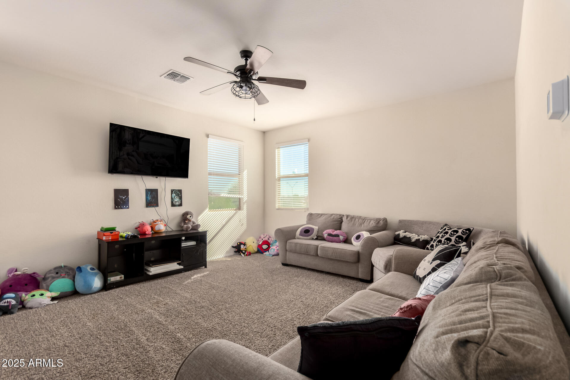 30879 West Picadilly Road Buckeye, AZ 85396 - Photo 16 of 34 a living room with furniture and a flat screen tv