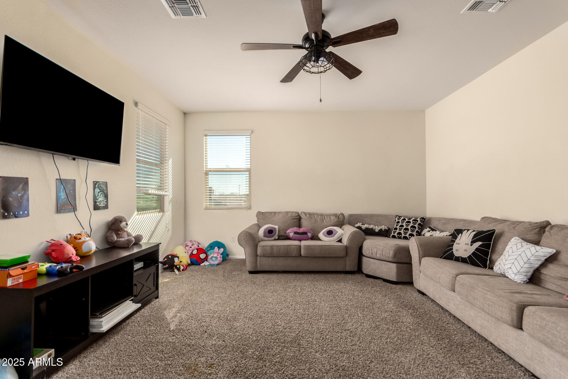 30879 West Picadilly Road Buckeye, AZ 85396 - Photo 18 of 34 a living room with furniture and a flat screen tv