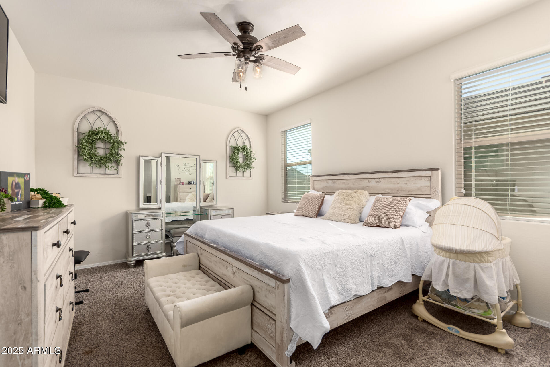 30879 West Picadilly Road Buckeye, AZ 85396 - Photo 19 of 34 a bedroom with a bed a chandelier and window