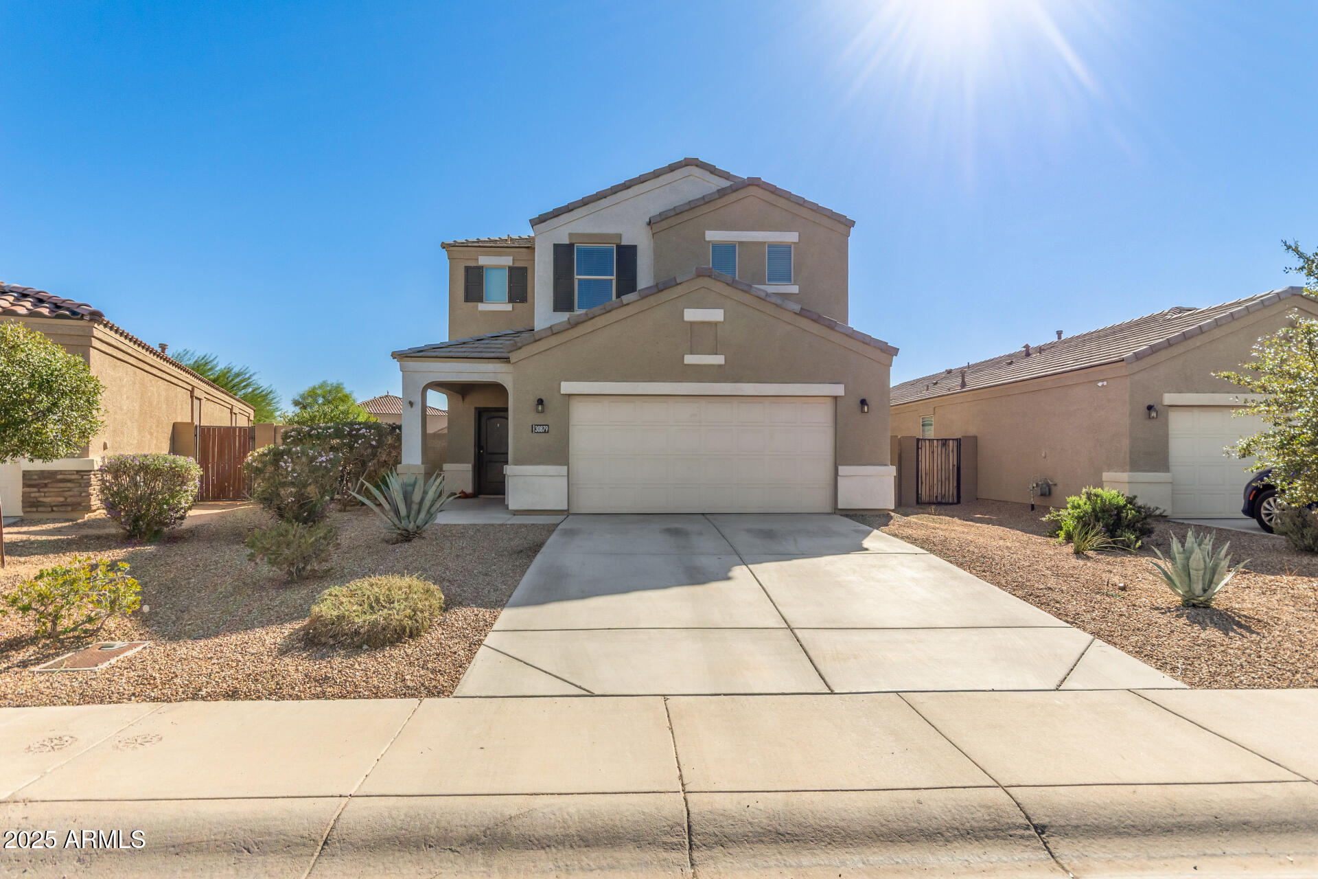 30879 West Picadilly Road Buckeye, AZ 85396 - Photo 2 of 34 a front view of a house with garden