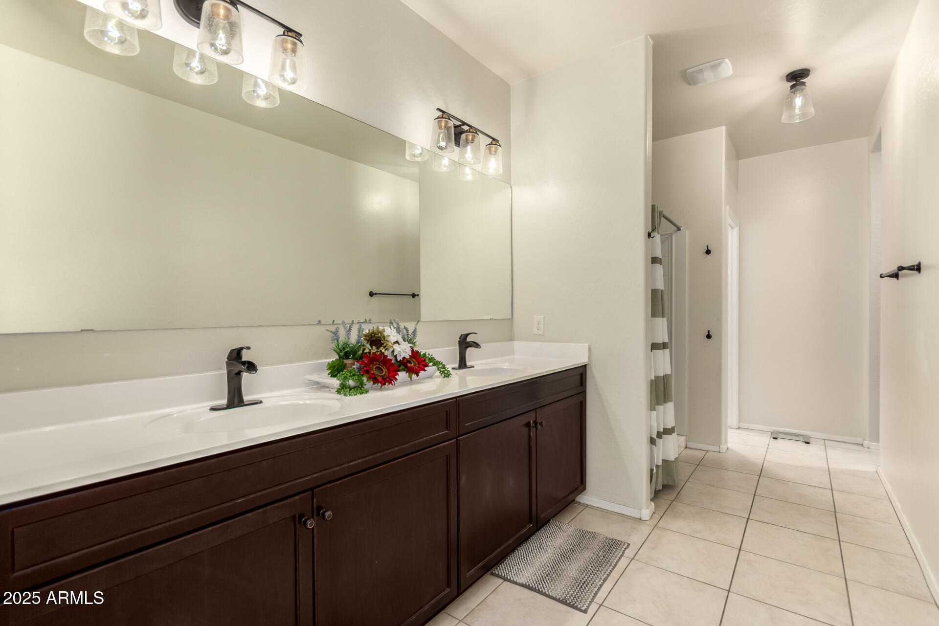 30879 West Picadilly Road Buckeye, AZ 85396 - Photo 22 of 34 a bathroom with a sink and a mirror