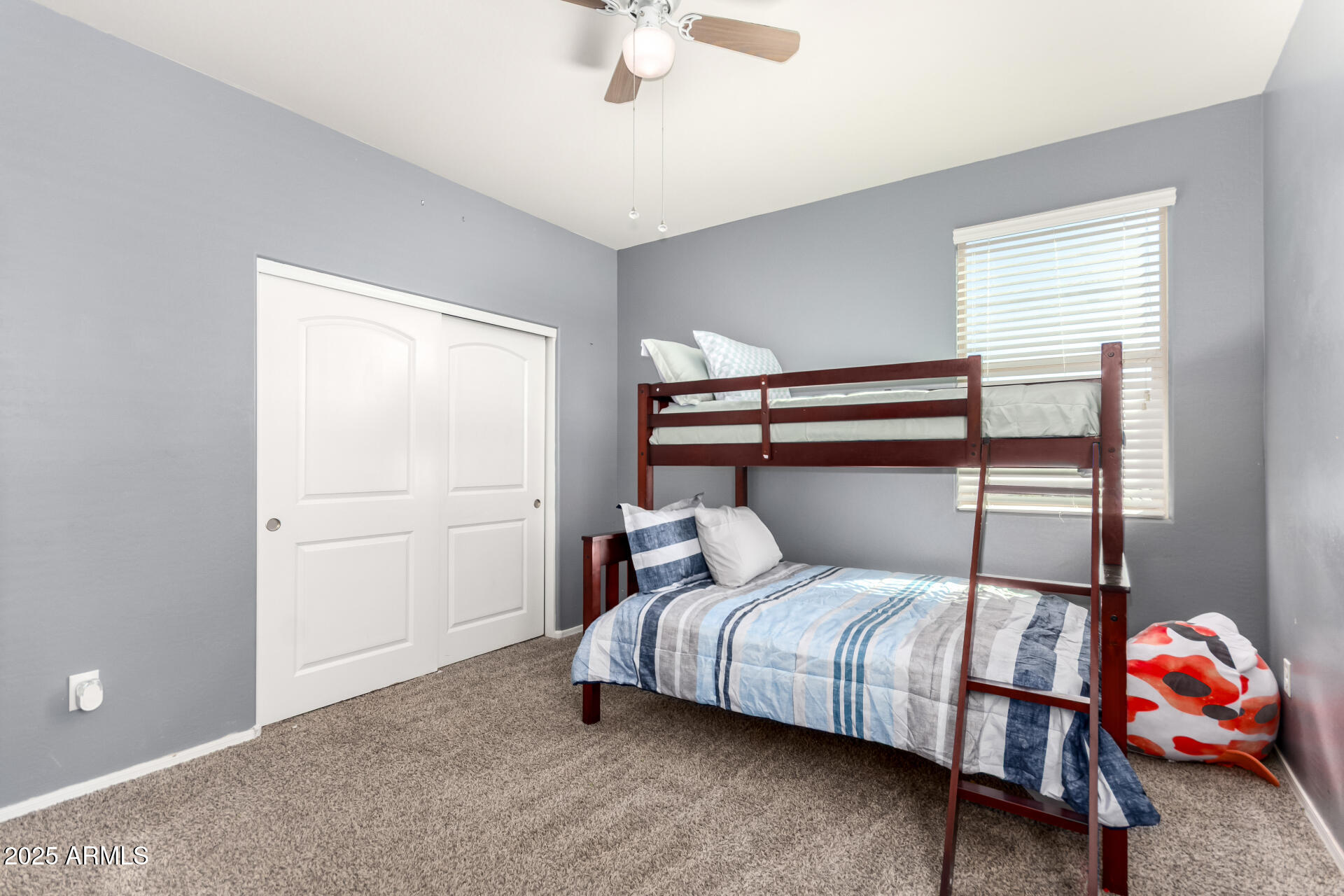 30879 West Picadilly Road Buckeye, AZ 85396 - Photo 26 of 34 a bedroom with a bed and a window