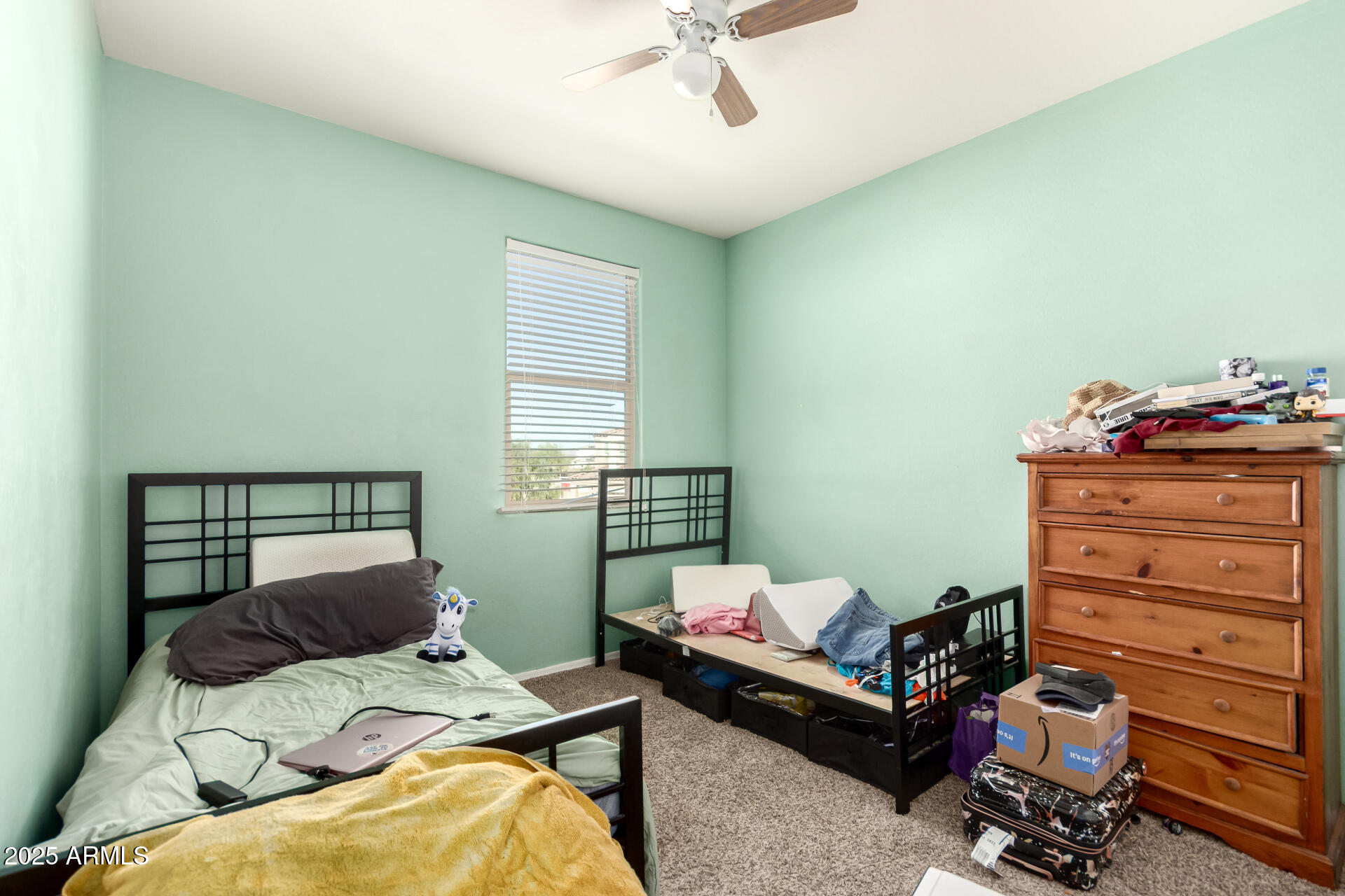 30879 West Picadilly Road Buckeye, AZ 85396 - Photo 27 of 34 a bedroom with a bed and a dresser