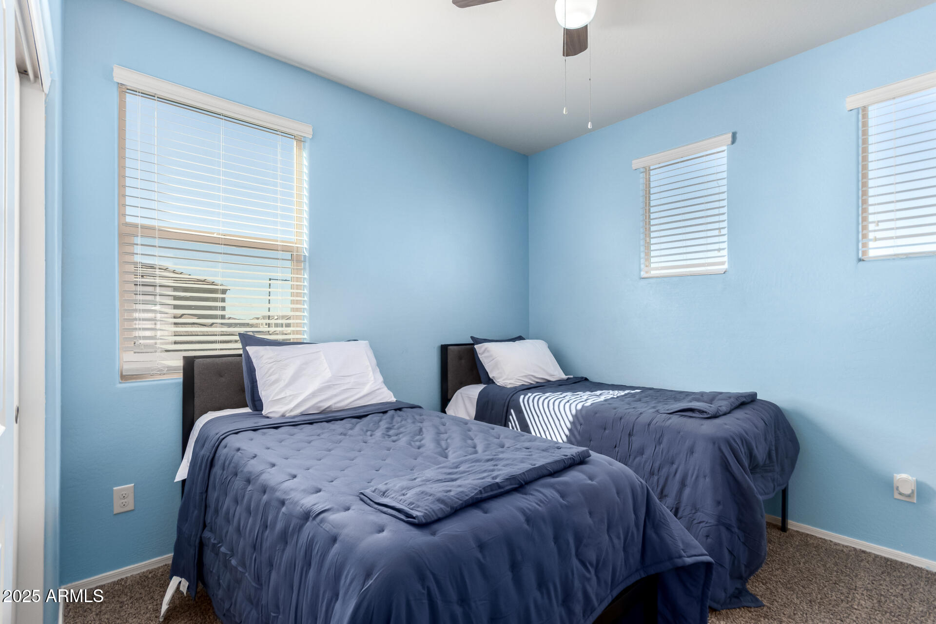 30879 West Picadilly Road Buckeye, AZ 85396 - Photo 28 of 34 a bedroom with two beds and a window