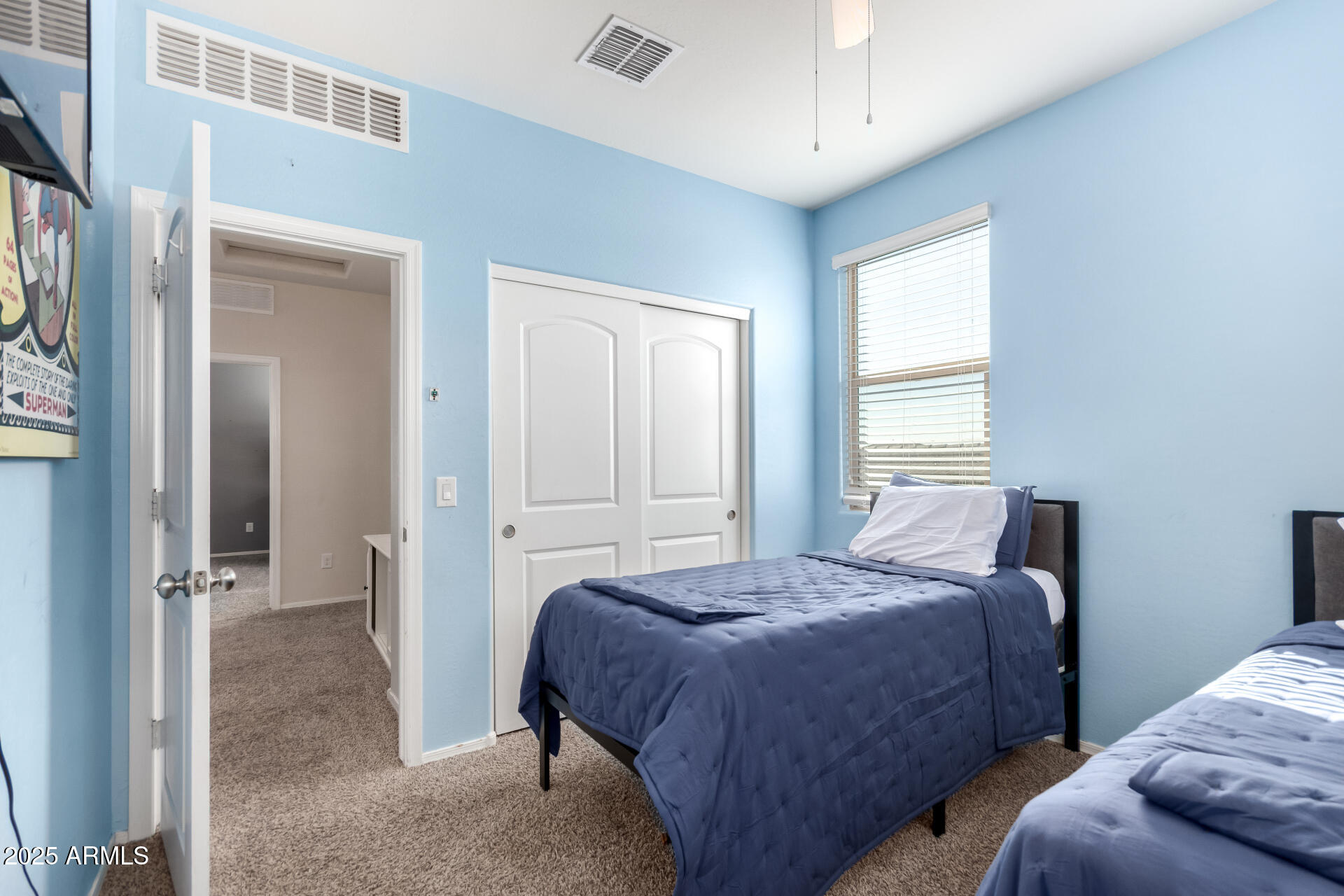 30879 West Picadilly Road Buckeye, AZ 85396 - Photo 29 of 34 a bedroom with two beds and a window