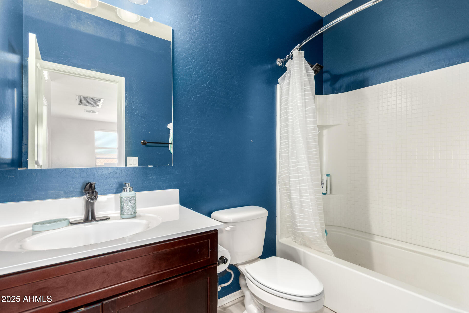 30879 West Picadilly Road Buckeye, AZ 85396 - Photo 30 of 34 a bathroom with a sink a toilet and shower