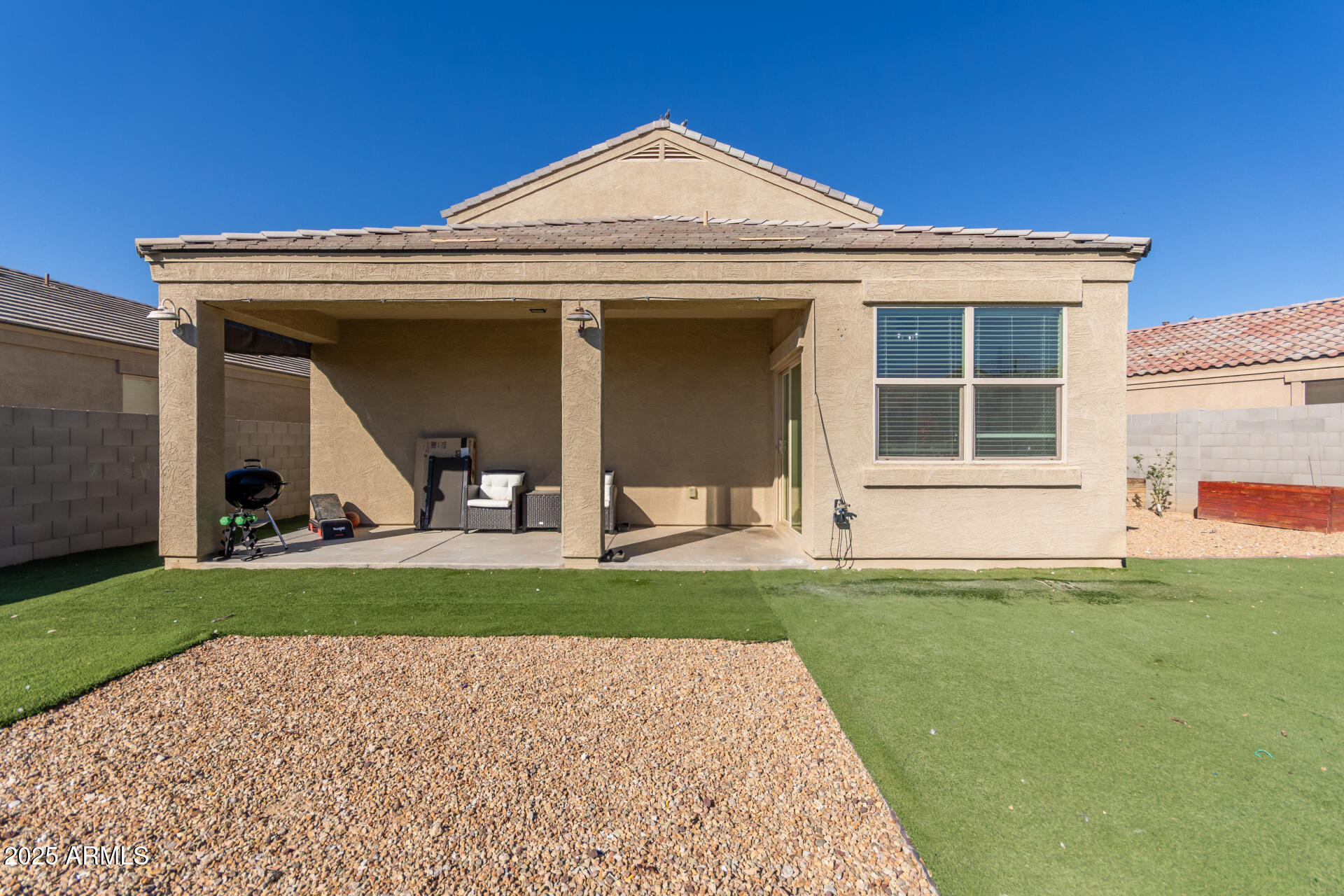 30879 West Picadilly Road Buckeye, AZ 85396 - Photo 31 of 34 a view of a house with a small yard and a large window