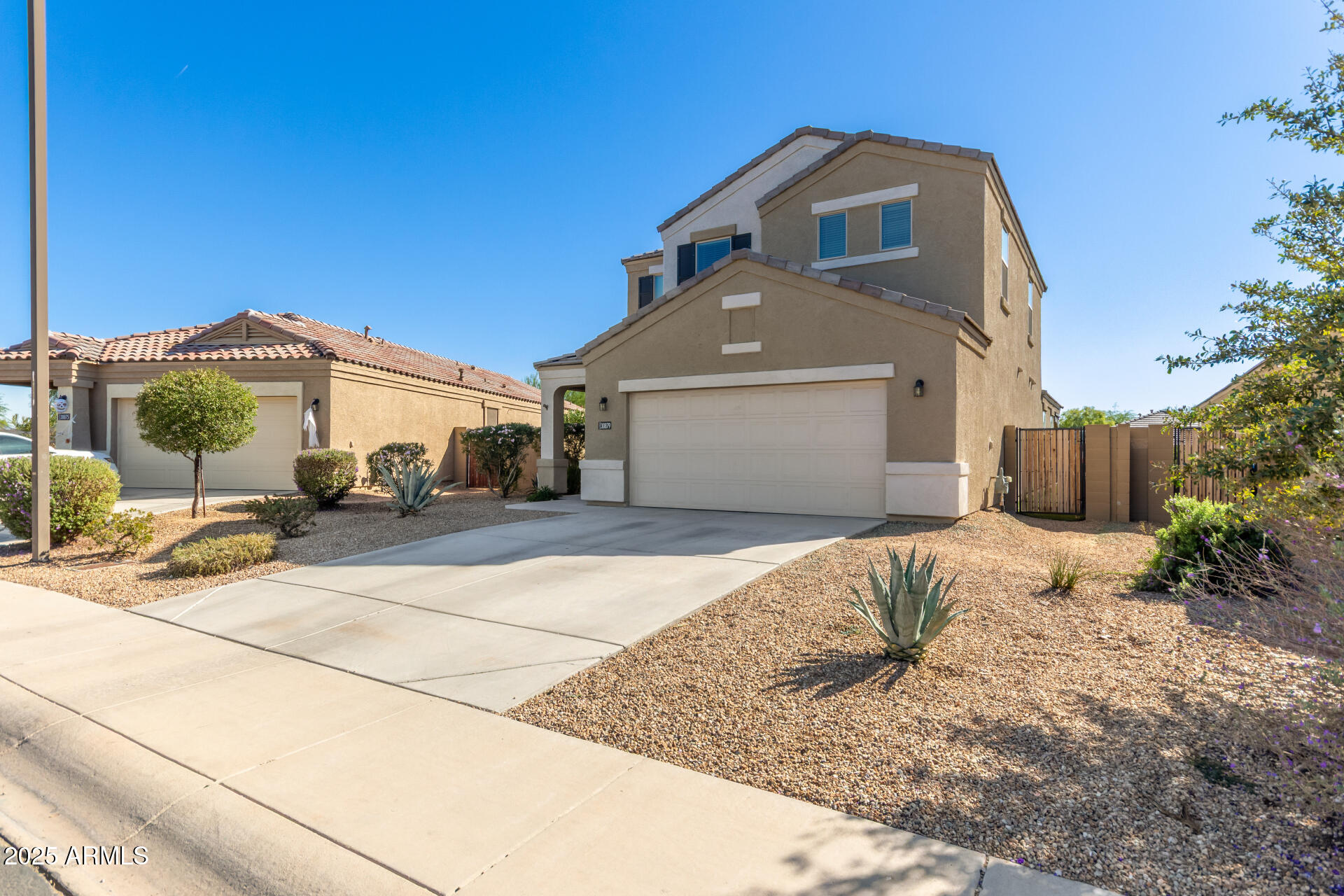 30879 West Picadilly Road Buckeye, AZ 85396 - Photo 4 of 34 a front view of a house with a yard