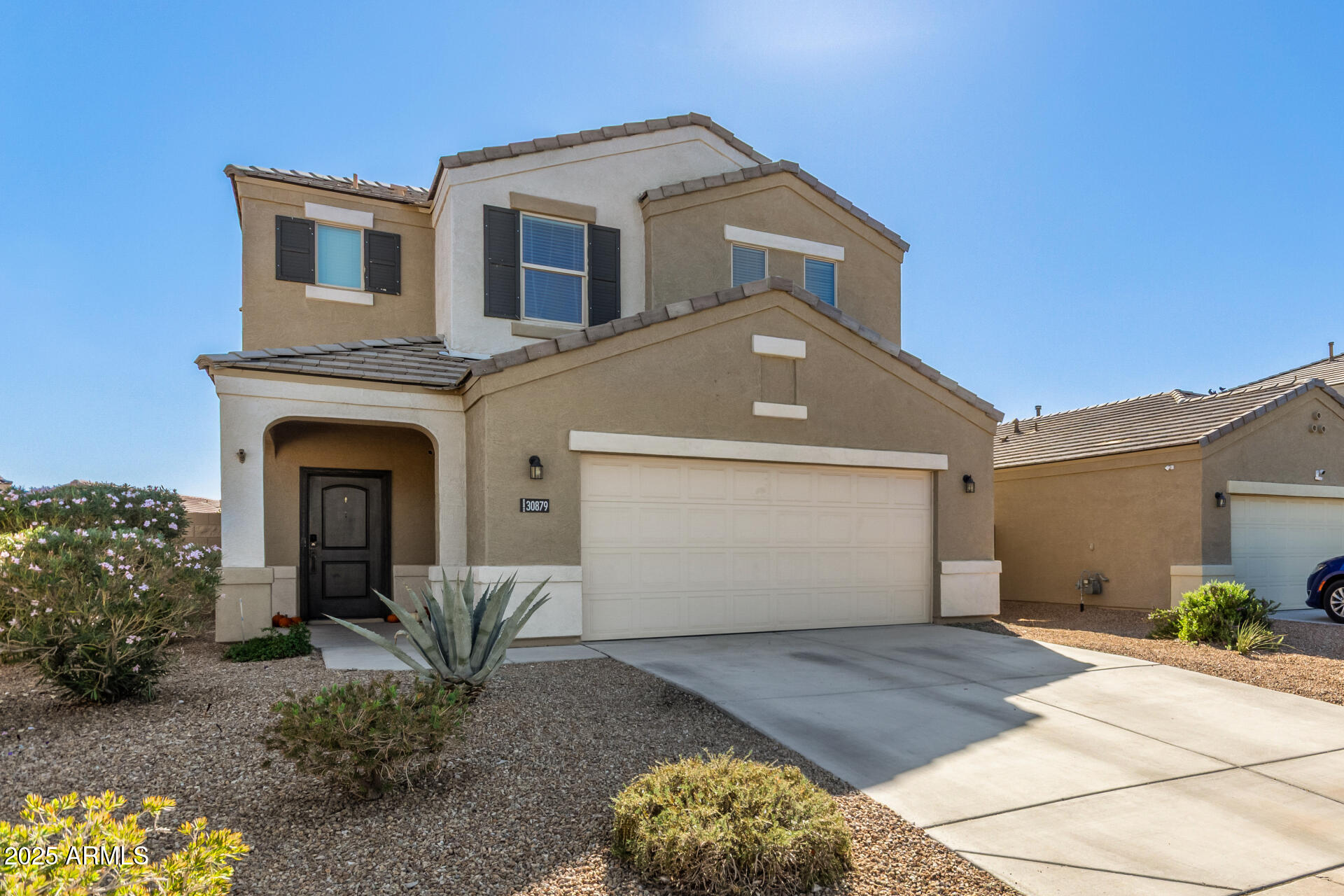 30879 West Picadilly Road Buckeye, AZ 85396 - Photo 5 of 34 a front view of a house with a yard