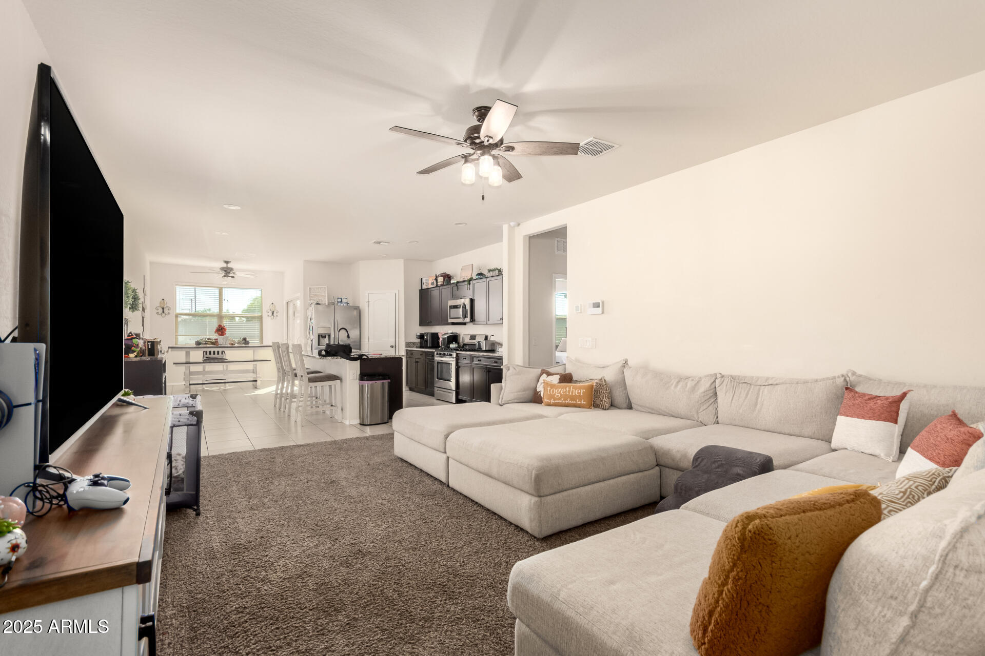 30879 West Picadilly Road Buckeye, AZ 85396 - Photo 8 of 34 a living room with furniture and a flat screen tv