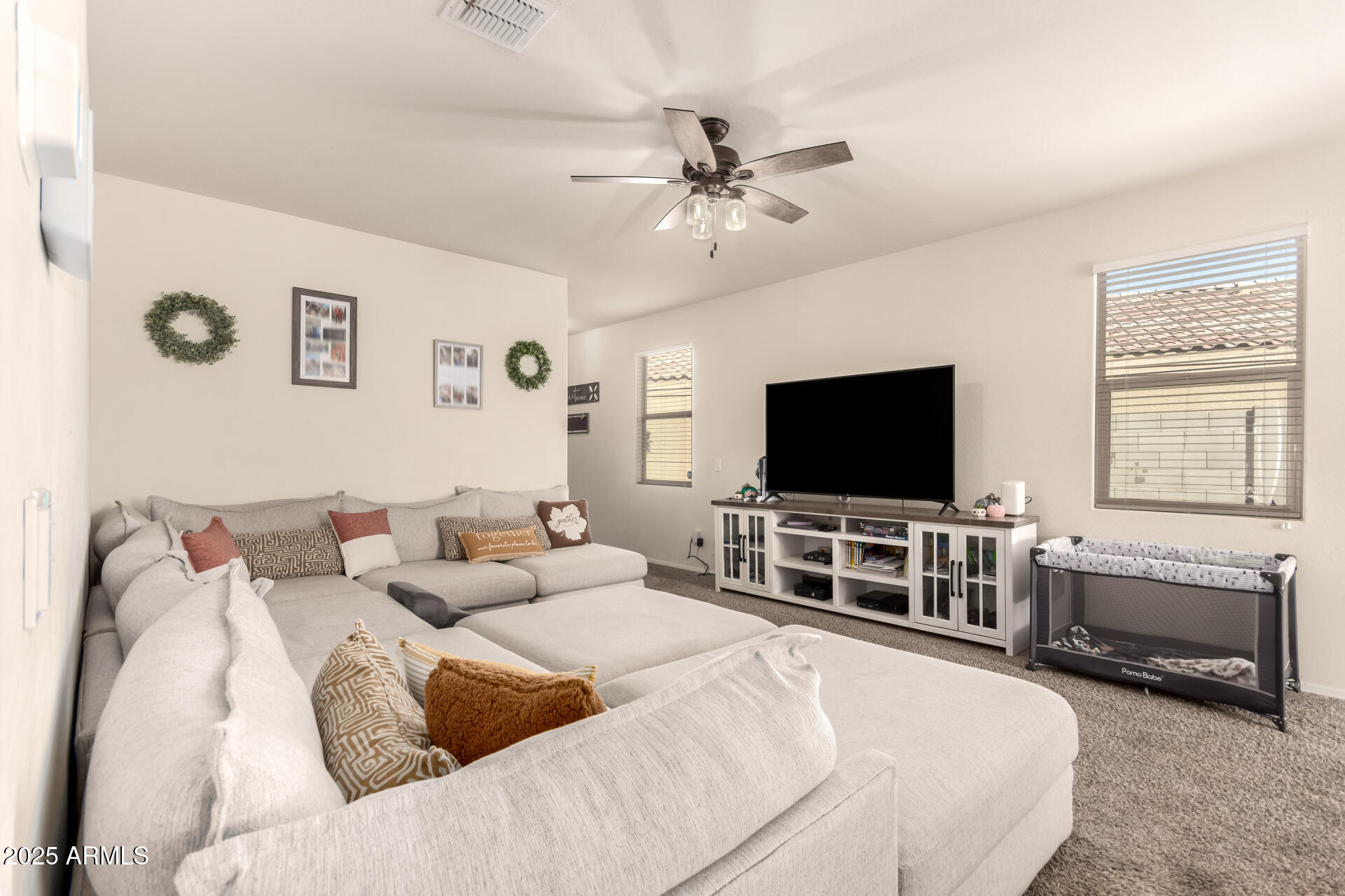 30879 West Picadilly Road Buckeye, AZ 85396 - Photo 9 of 34 a living room with furniture and a flat screen tv